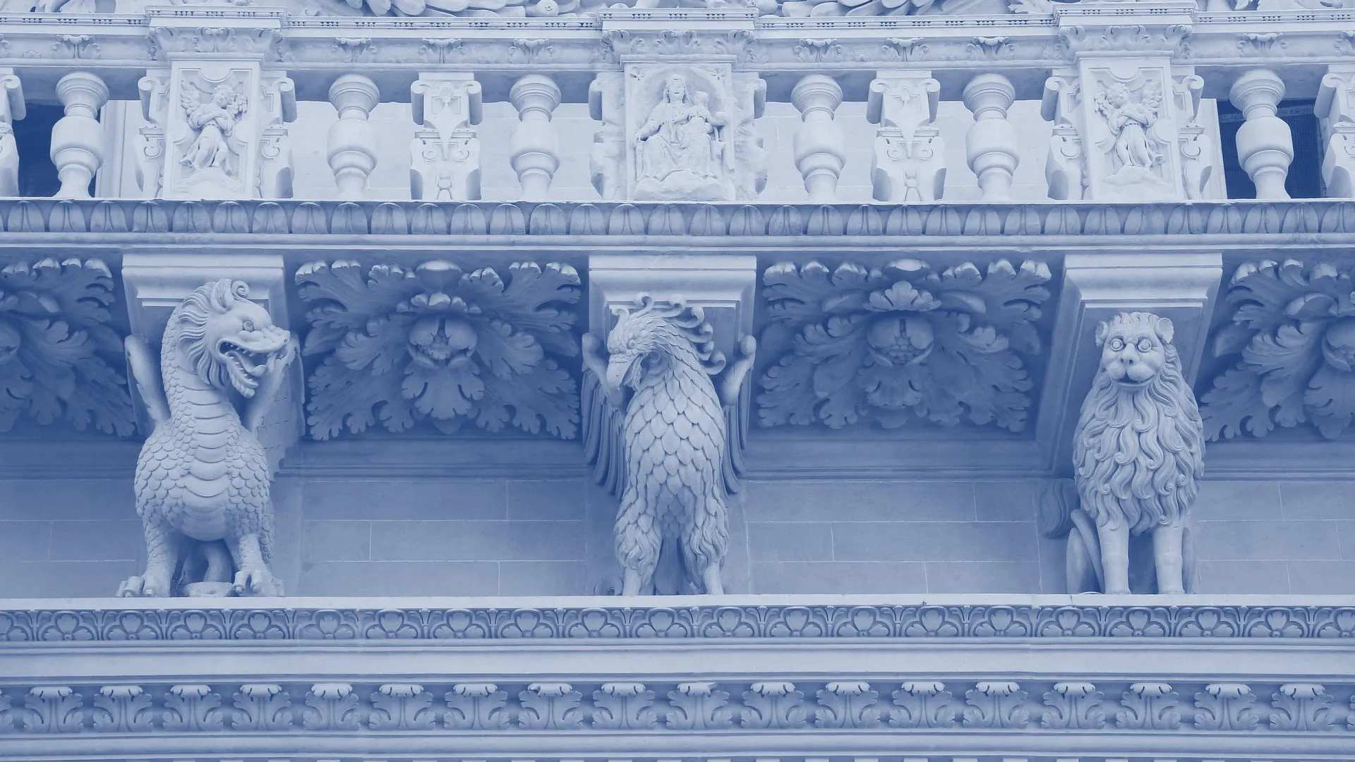 Baroque stone carvings on the facade of the Basilica of Santa Croce in Lecce: a dragon, an eagle and a lion under a balustrade carved with angels and a Madonna and Child, printed in blue duotone